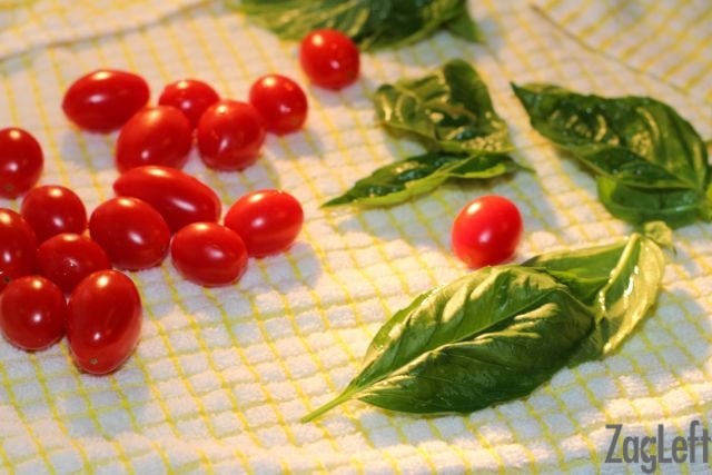 Cherry tomatoes and basil on a towel