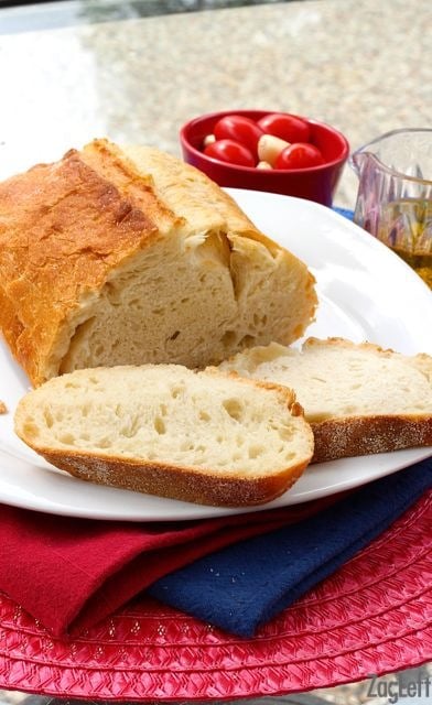 Loaf french bread with two slices on a plate
