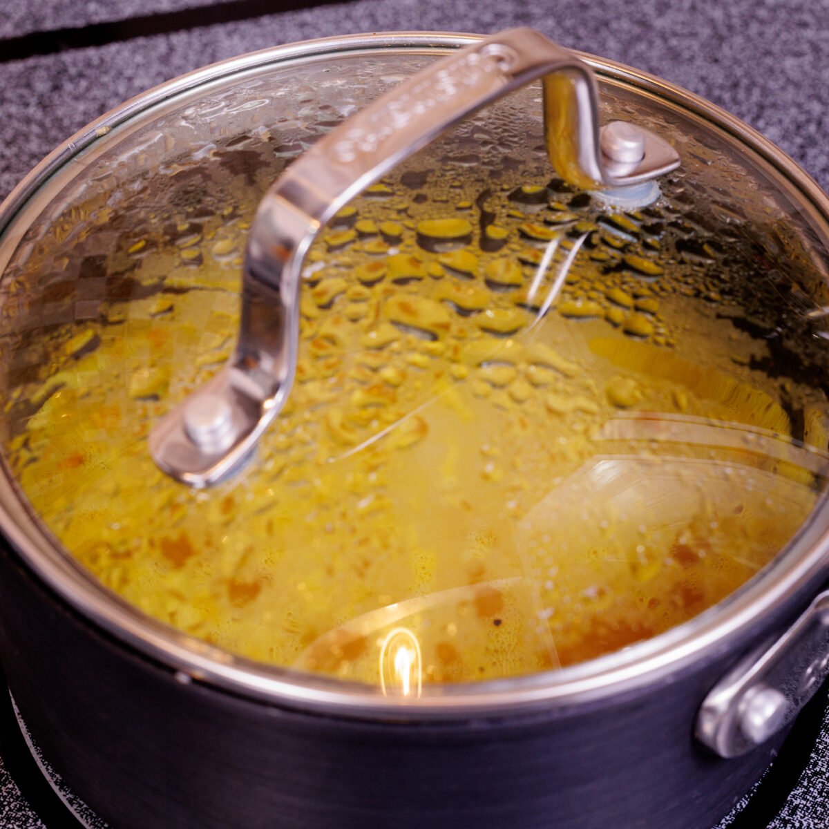 golden rice simmering in a pot.
