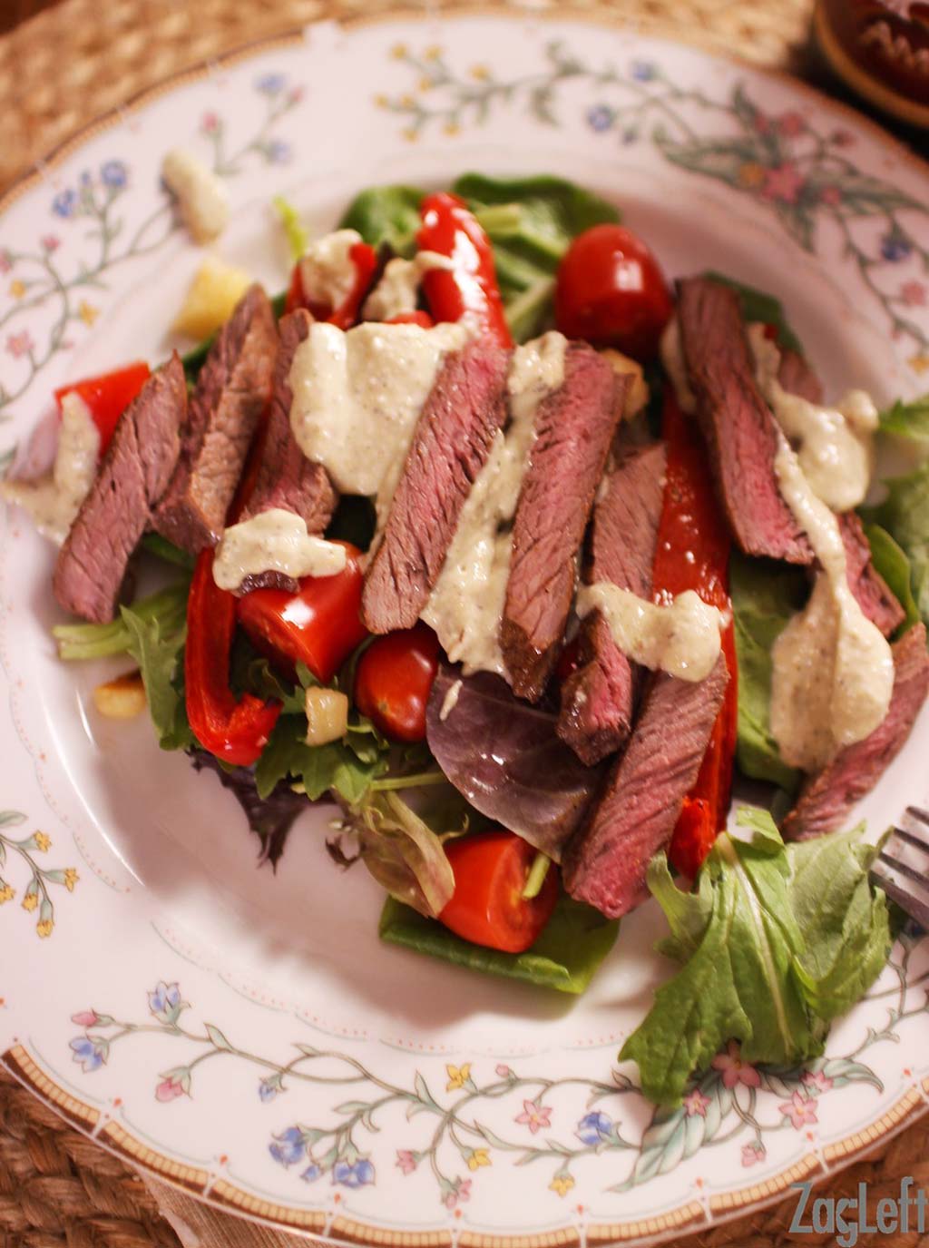 An overhead view of a Steak Salad with Gorgonzola Dressing.