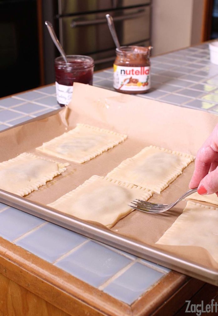 Sealing the dough with a fork on each toaster pastry. 