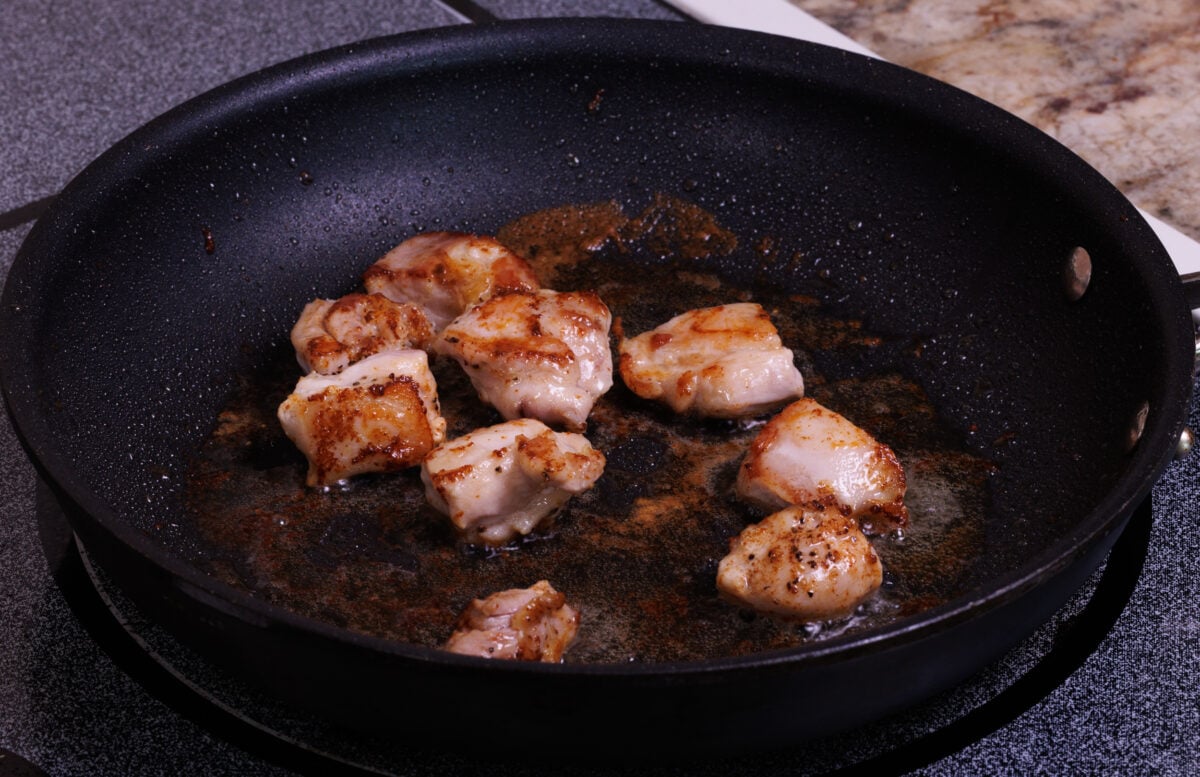 pieces of chicken browning in a small skillet