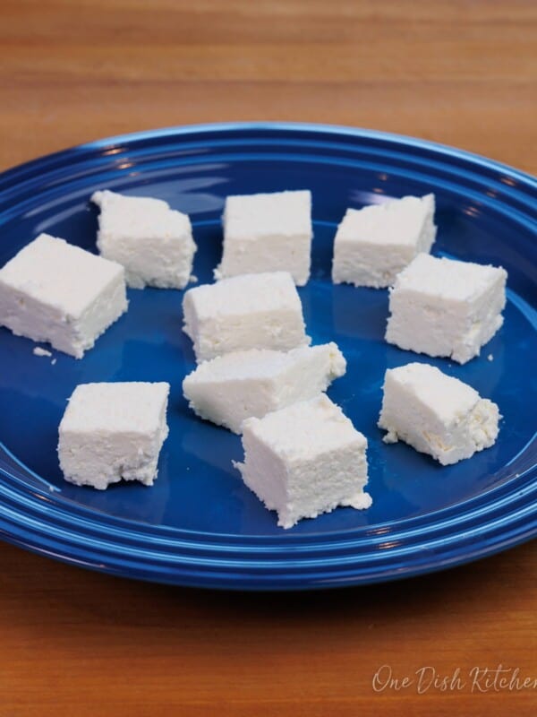 cubes of paneer on a blue plate