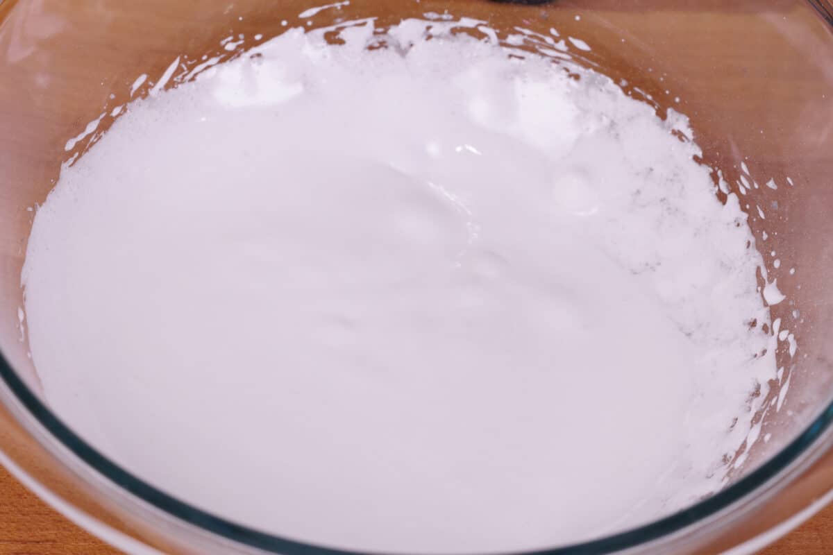 egg white whipped to soft peaks in a mixing bowl
