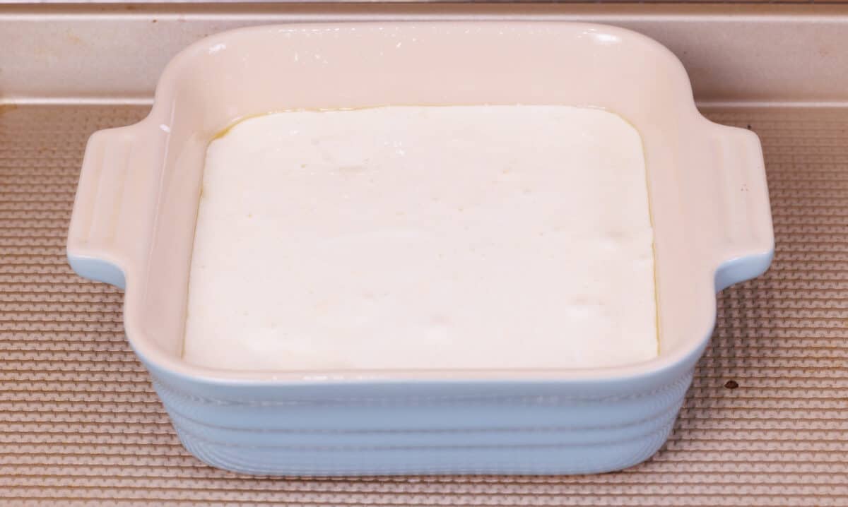 tres leches cake batter in a small baking dish