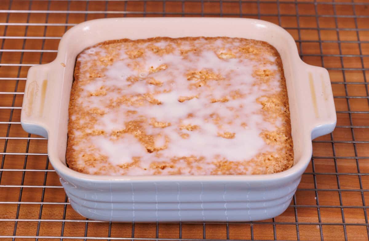 a small tres leches cake with three milks poured over the top