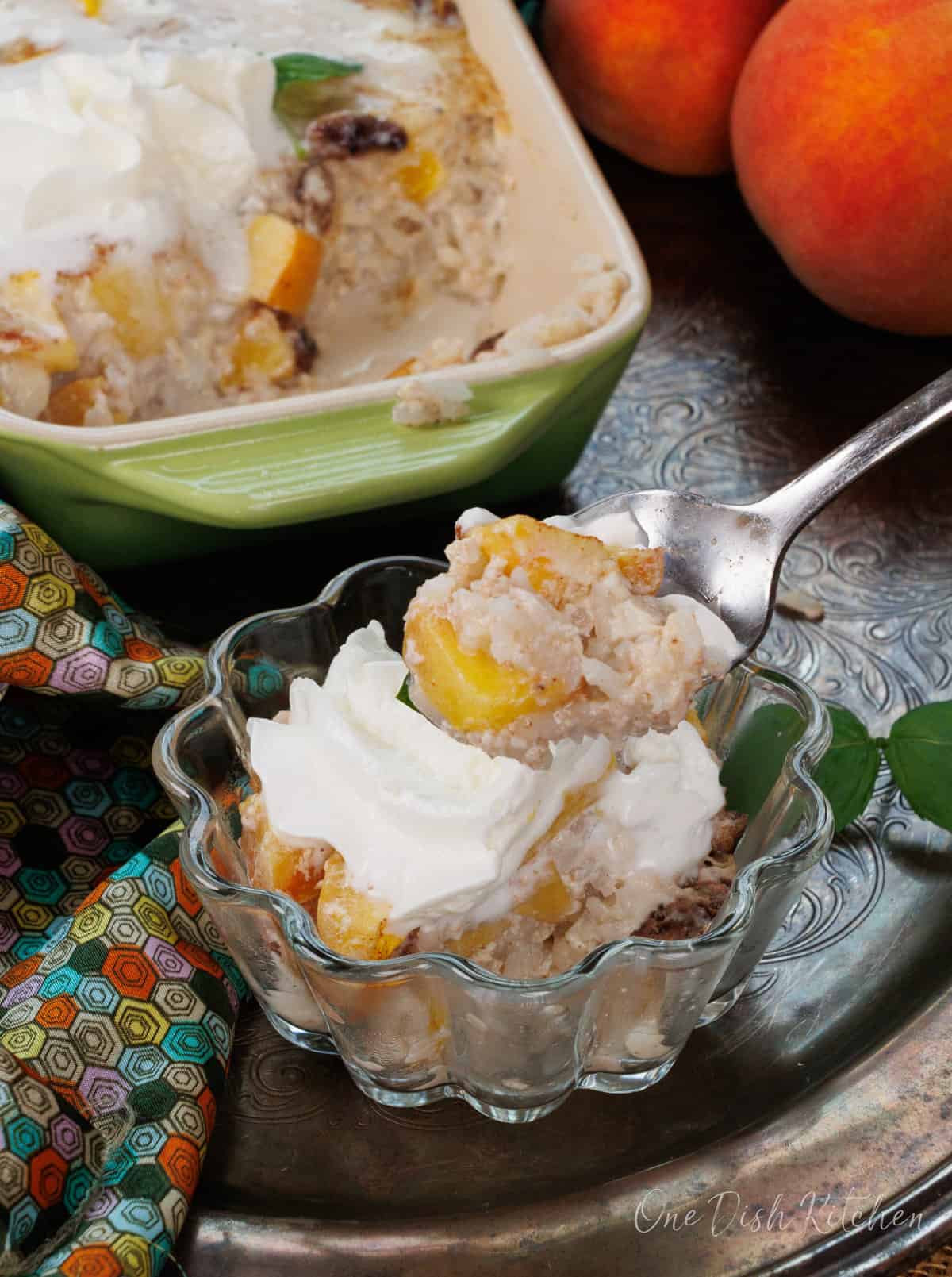 a small teaspoon of peach rice pudding over a dessert dish