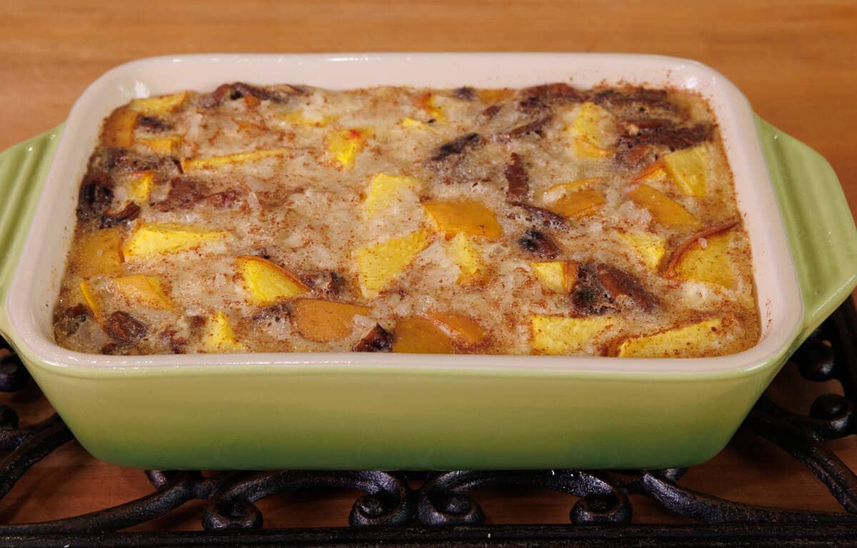 a baked peaches and cream rice pudding on a cooling rack