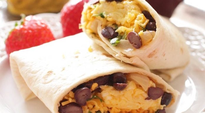 Huevos Rancheros Make Ahead Breakfast Burritos filled with spicy black beans, onions and garlic, eggs, cheese and cilantro. Make a bunch and freeze for easy grab and go breakfasts. | One Dish Kitchen