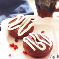 two red velvet donuts with white frosting