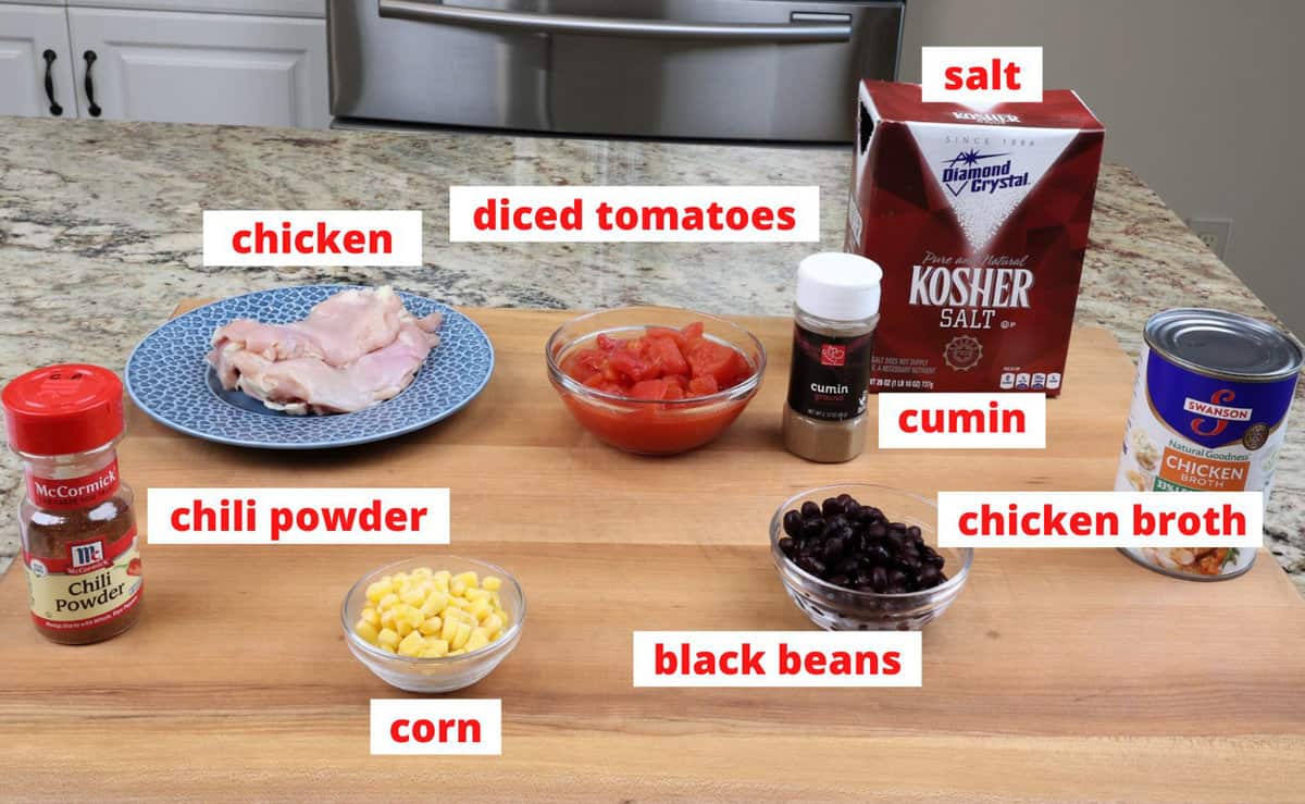ingredients in a slow cooker chicken burrito bowl on a kitchen counter.