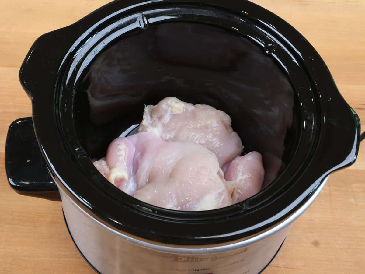 chicken in the base of a small slow cooker.