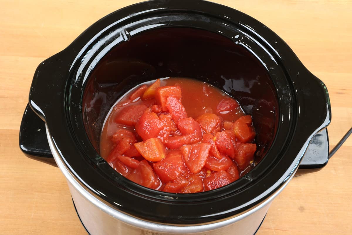 chicken and tomatoes in a small slow cooker.