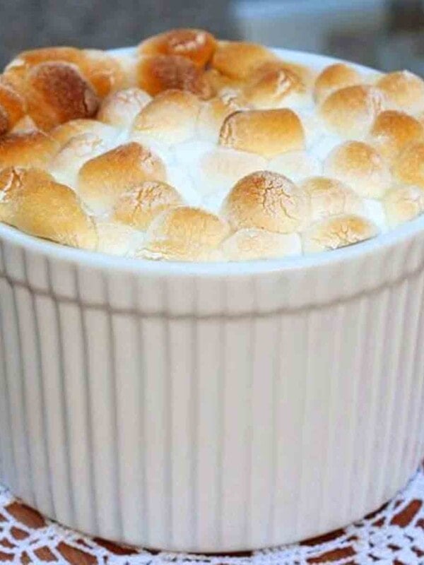 a mini sweet potato casserole in a small ramekin topped with marshmallows