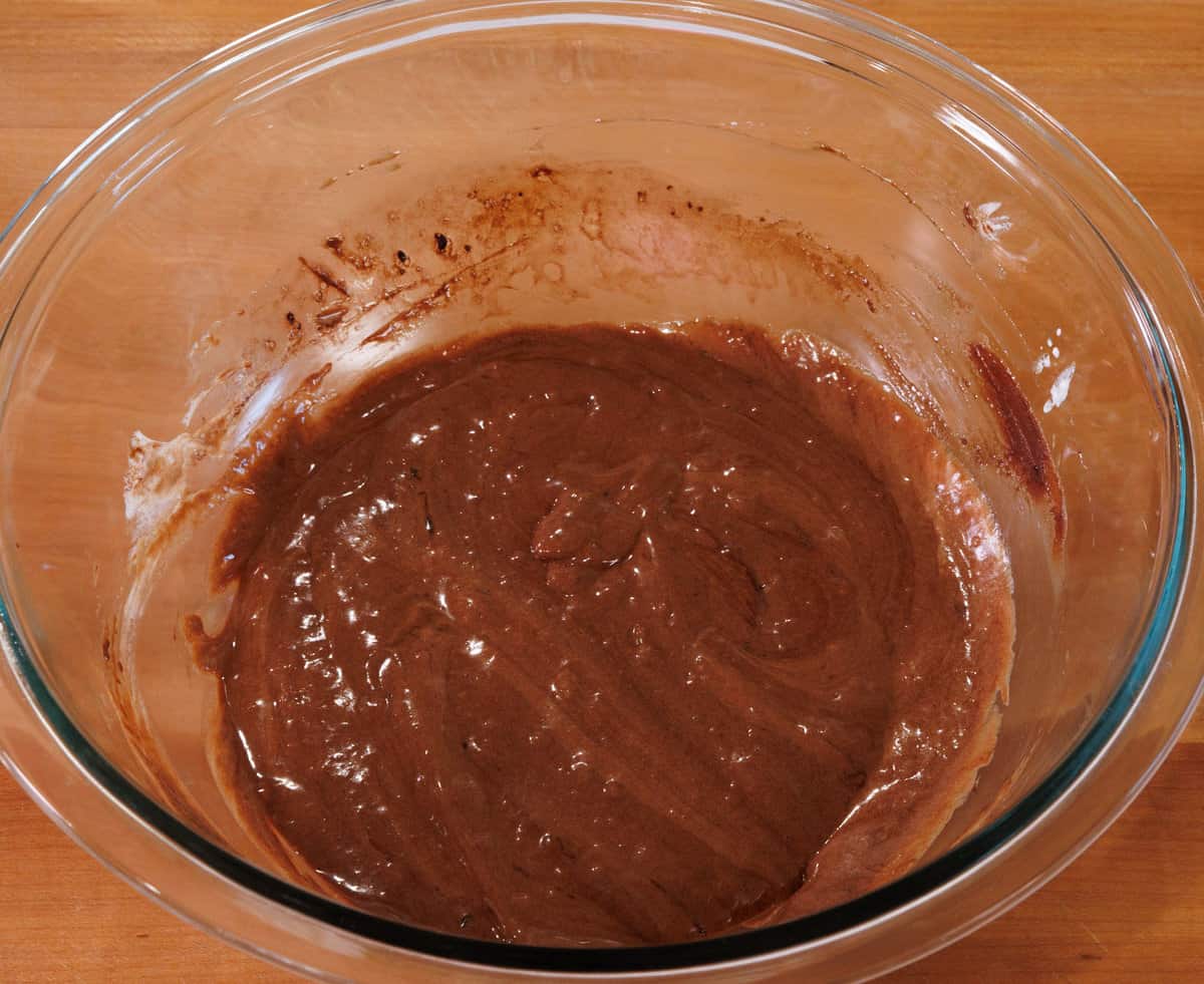 flourless chocolate cake batter in a clear mixing bowl.