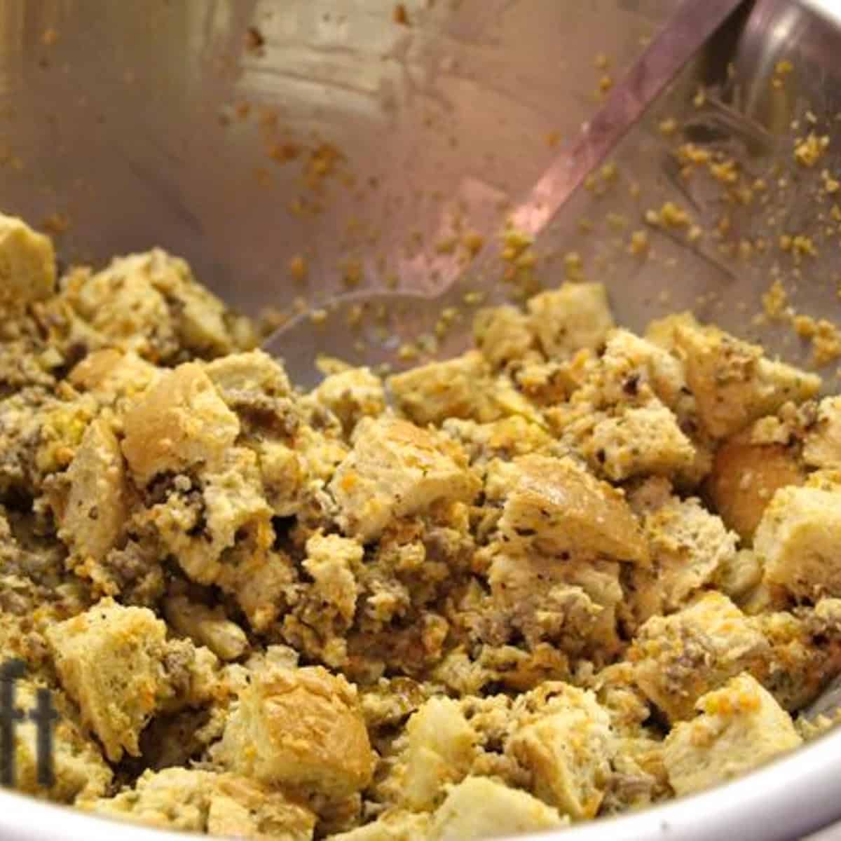 uncooked sausage stuffing in a mixing bowl.