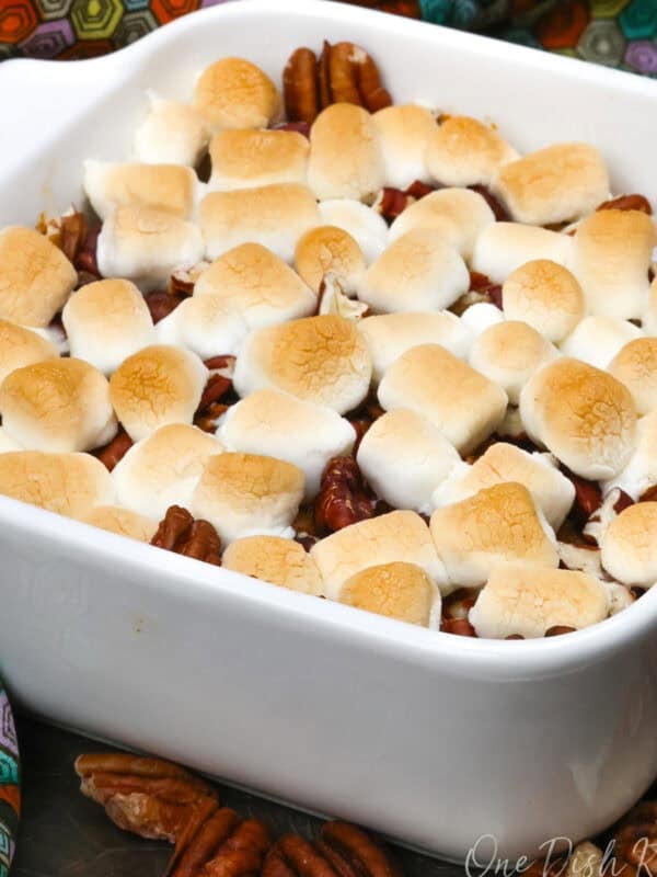 a small sweet potato casserole with marshmallows on a silver tray.