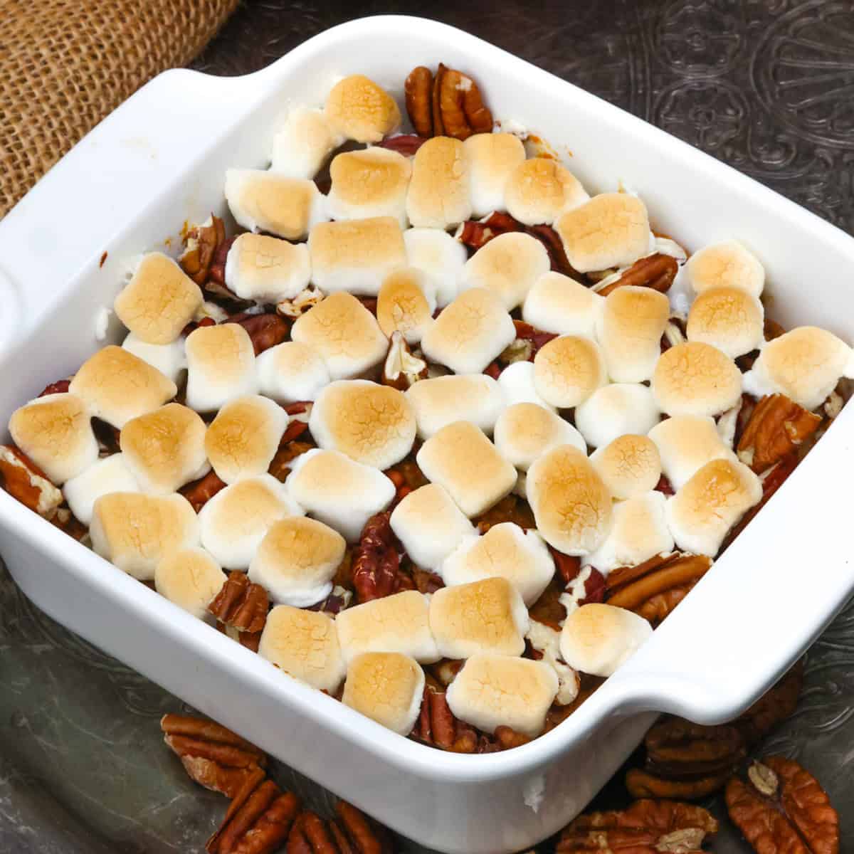 a mini sweet potato casserole with marshmallows in a small baking dish.