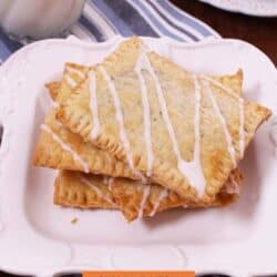 three homemade toaster pastries on a white plate.