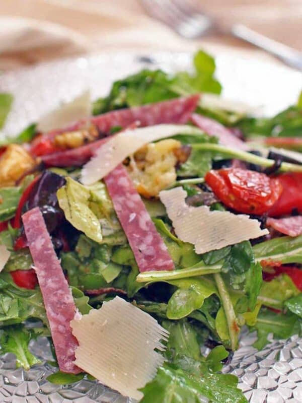 Spinach Antipasto Salad on a glass dish.