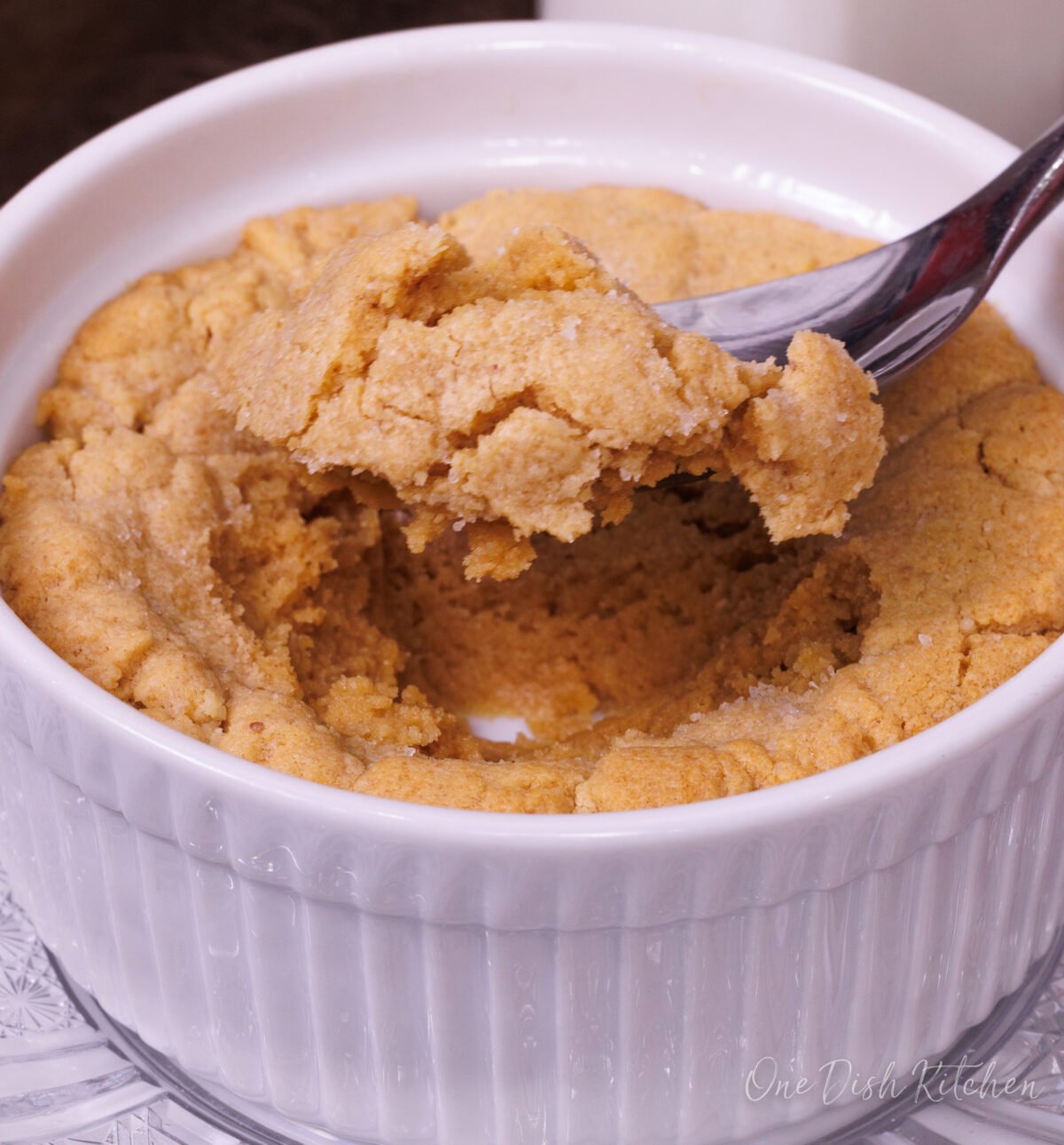 a peanut butter cookie eaten with a spoon from a small ramekin.