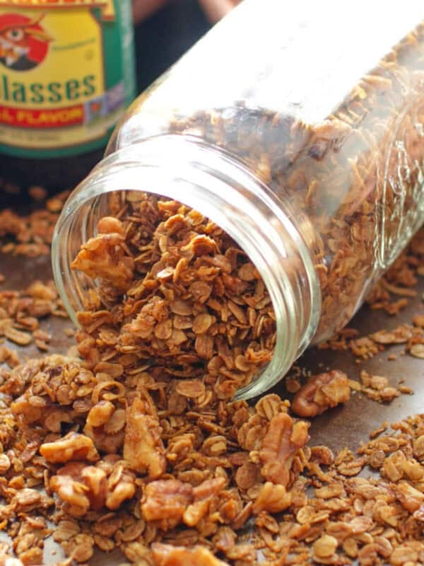 a small jar of gingerbread granola spilled out on a table.