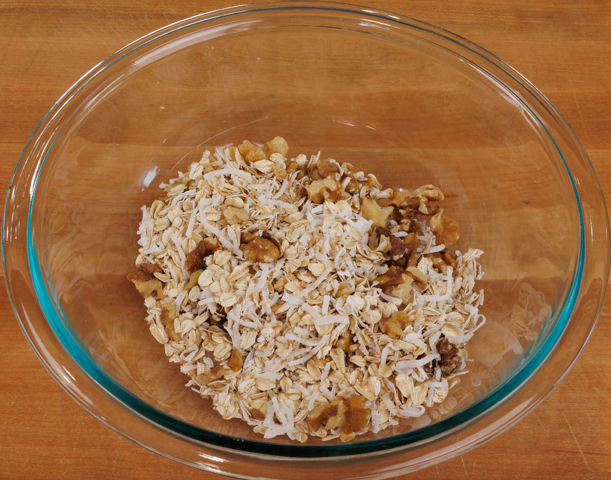 oats, nuts, coconut, and sugar in a large mixing bowl