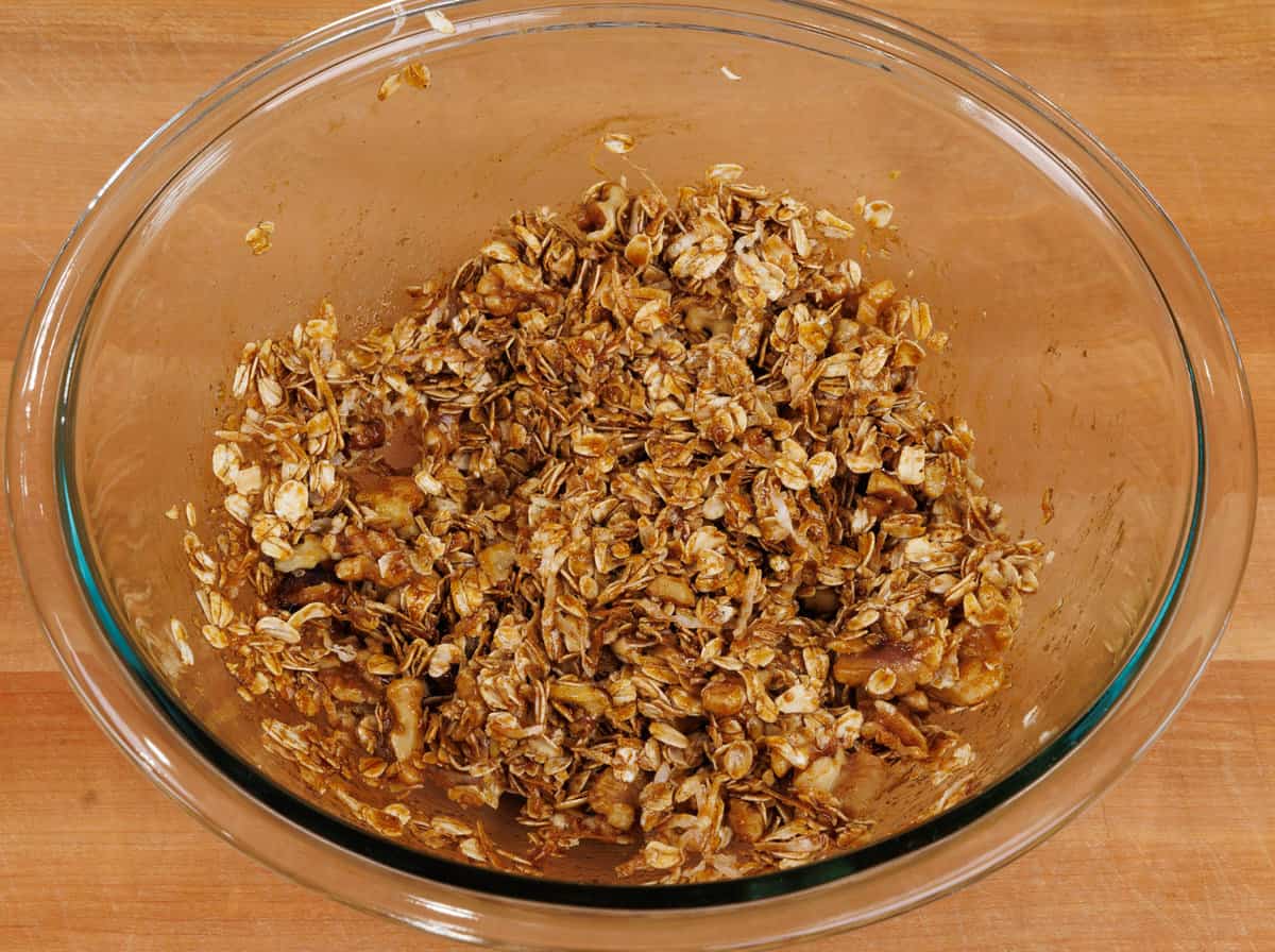unbaked gingerbread granola in a mixing bowl
