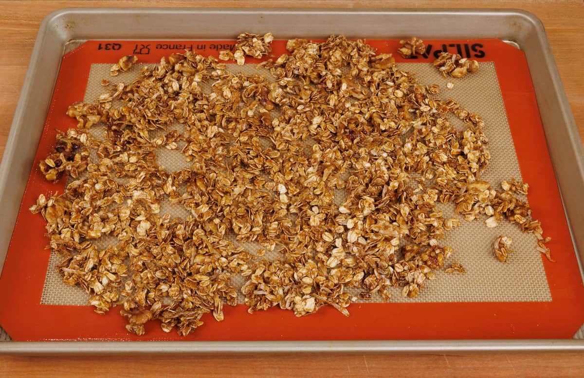 unbaked granola spread evenly over a baking sheet.
