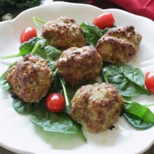 a small batch of turkey meatballs on a white plate.