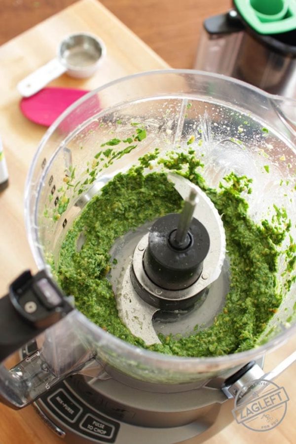 spinach leaves, toasted pin nuts and garlic mixture after processing in a food processor