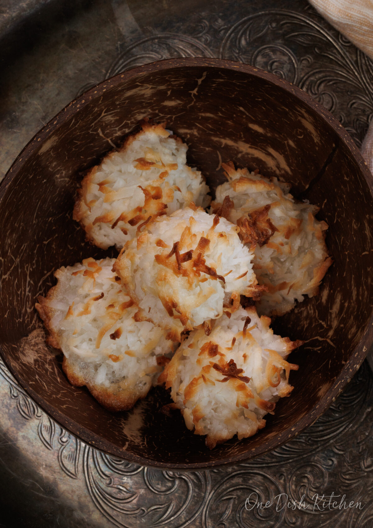 five coconut macaroons in a brown bowl