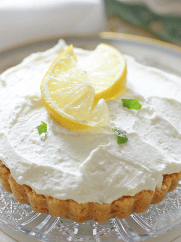 Lemon Cheesecake Mousse with crust on glass plate.