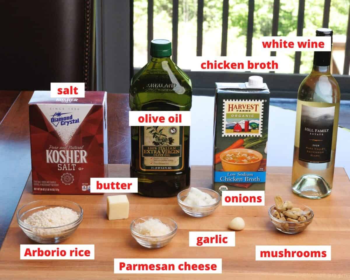 risotto ingredients on a wooden cutting board.