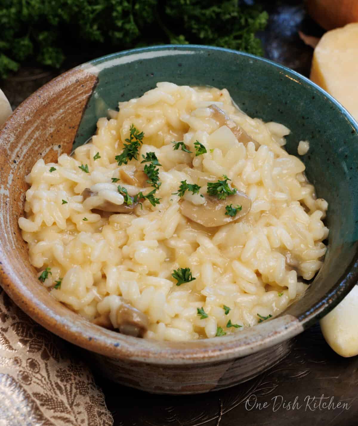 risotto in a bowl topped with fresh parsley.