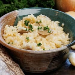 a green bowl full of risotto on a silver tray