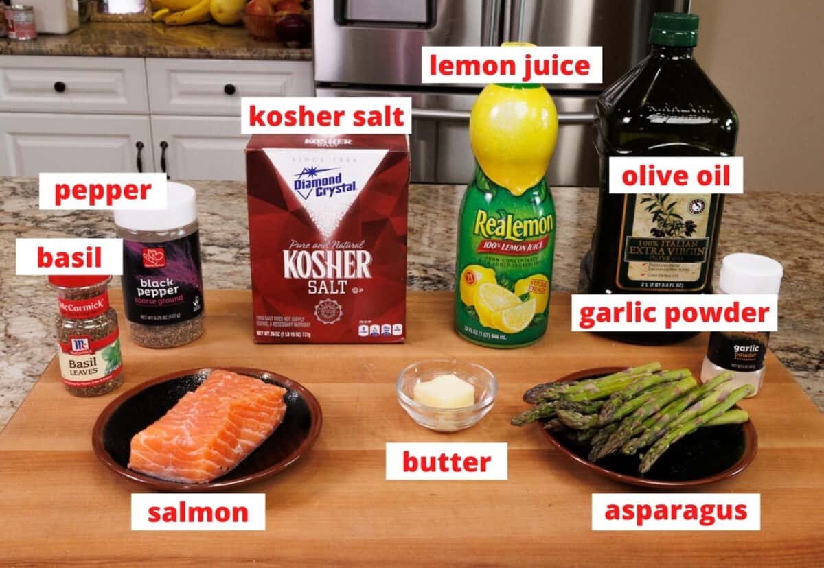 ingredients to make roasted salmon on a wooden cutting board in a kitchen