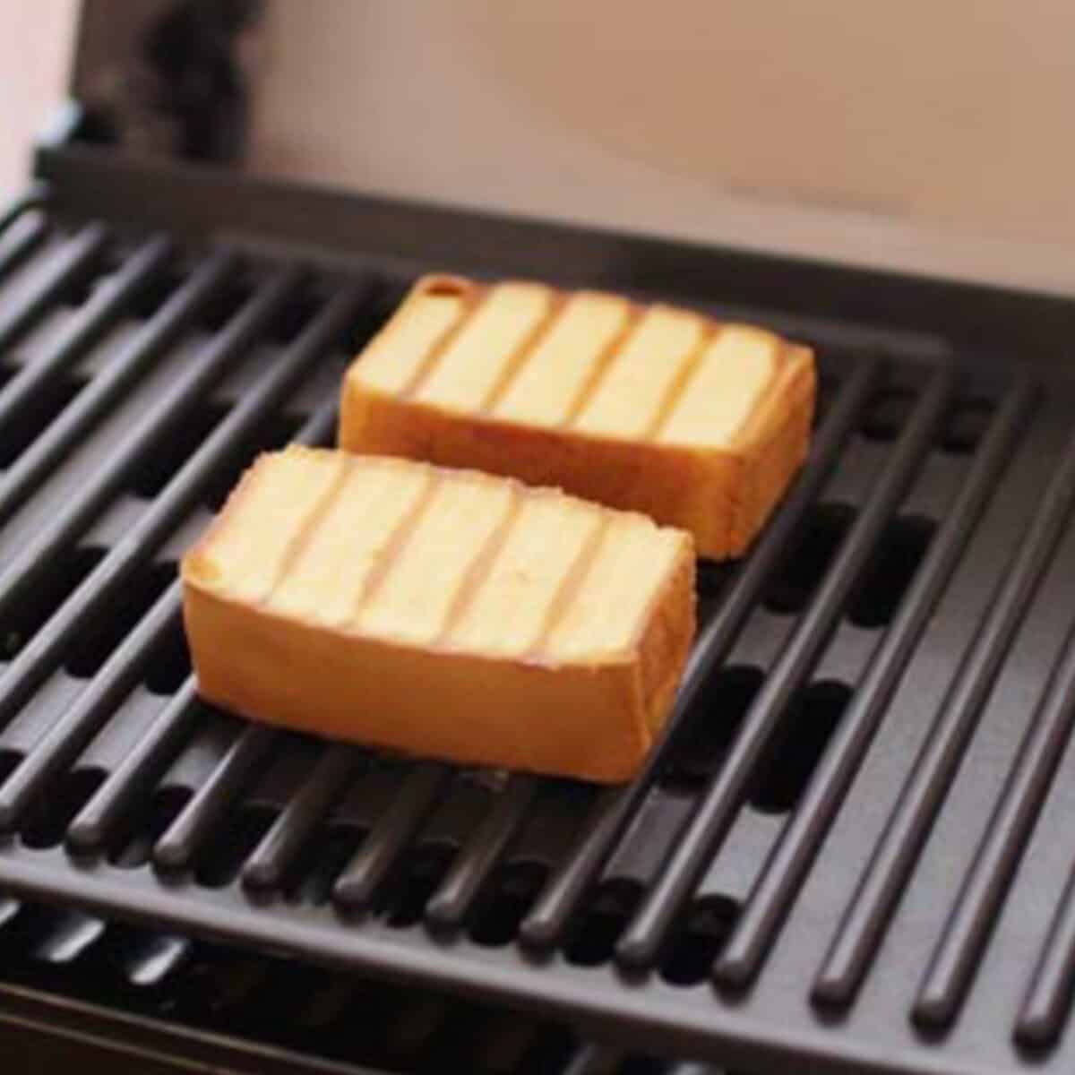 two slices of pound cake on a grill