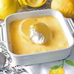 Lemon mango pie with sliced lemon and whipped cream on top.