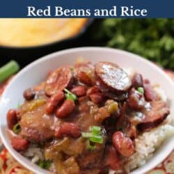 a bowl of red beans and rice topped with sliced green onions next to a plate of cornbread.