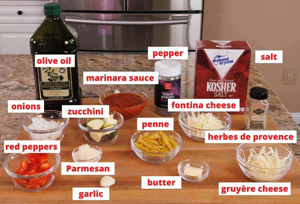 ingredients in baked penne casserole on a cutting board in a kitchen