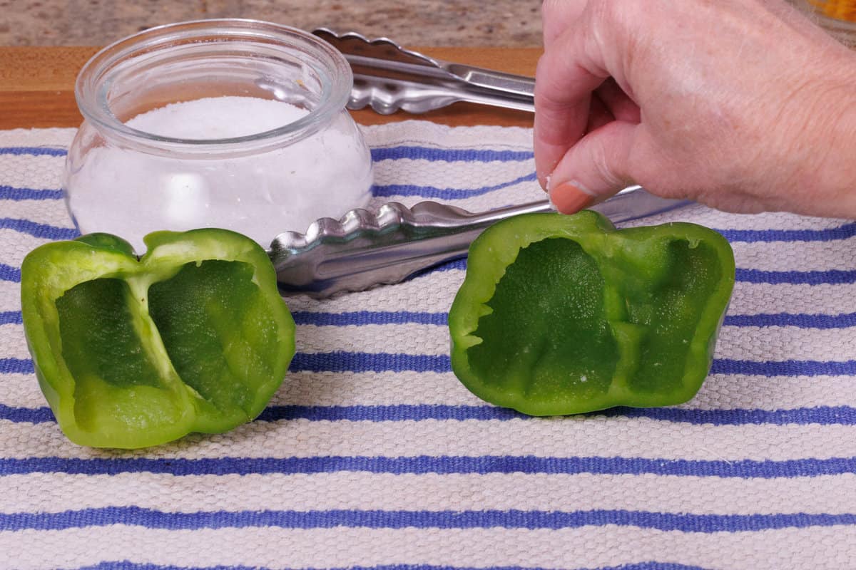 sprinkling salt over bell peppers