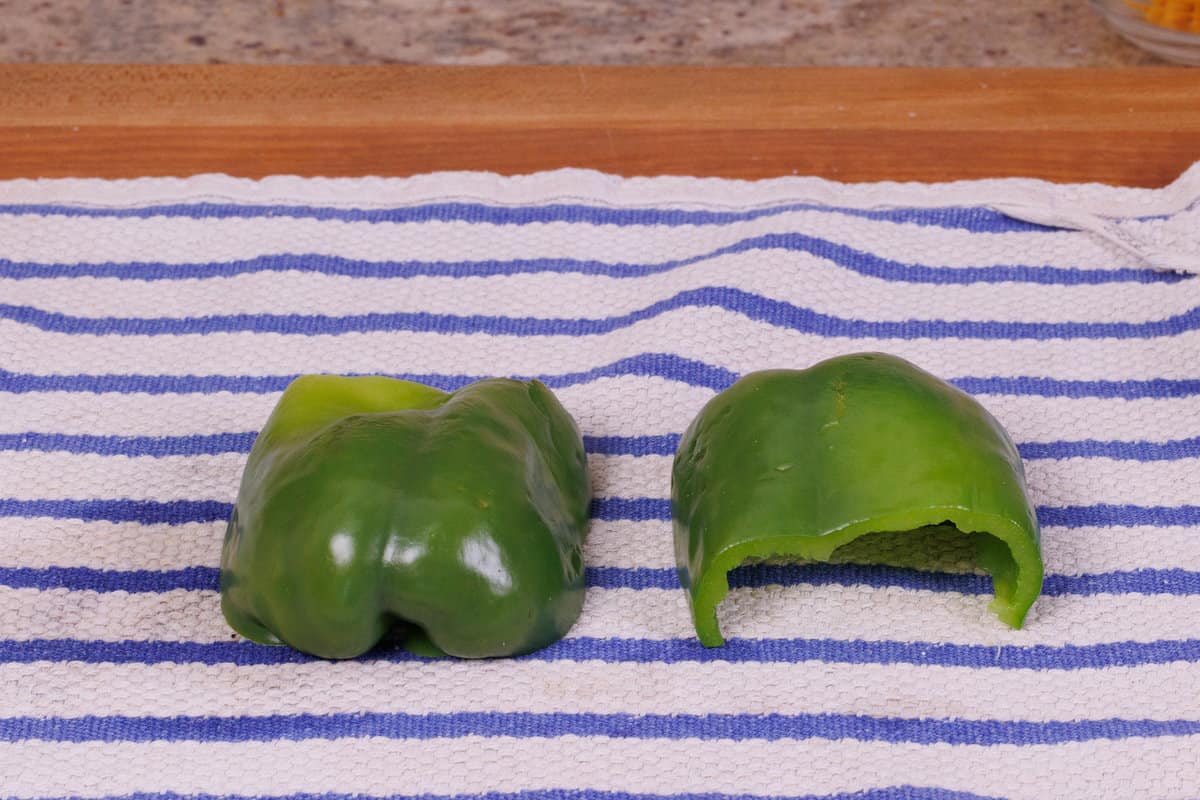 two bell pepper halves on a kitchen towel