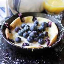 Dutch Baby Pancake with berries on top in mini skillet