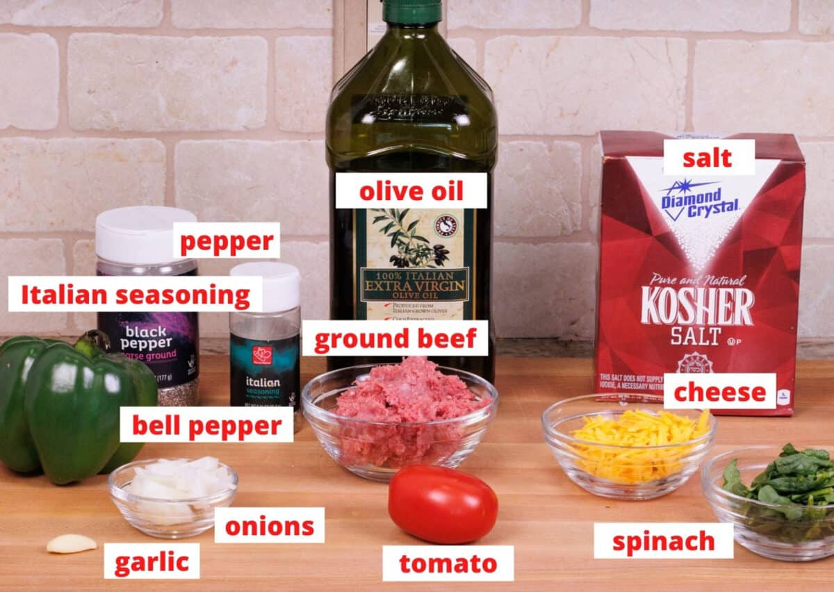 ingredients needed to make stuffed peppers on a wooden cutting board