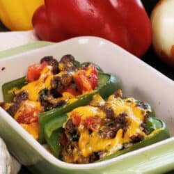two stuffed bell peppers in a baking dish