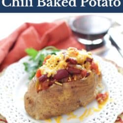 a baked potato topped with chili and cheese on a white plate.
