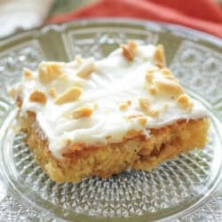 a slice of pineapple sheet cake on a plate.
