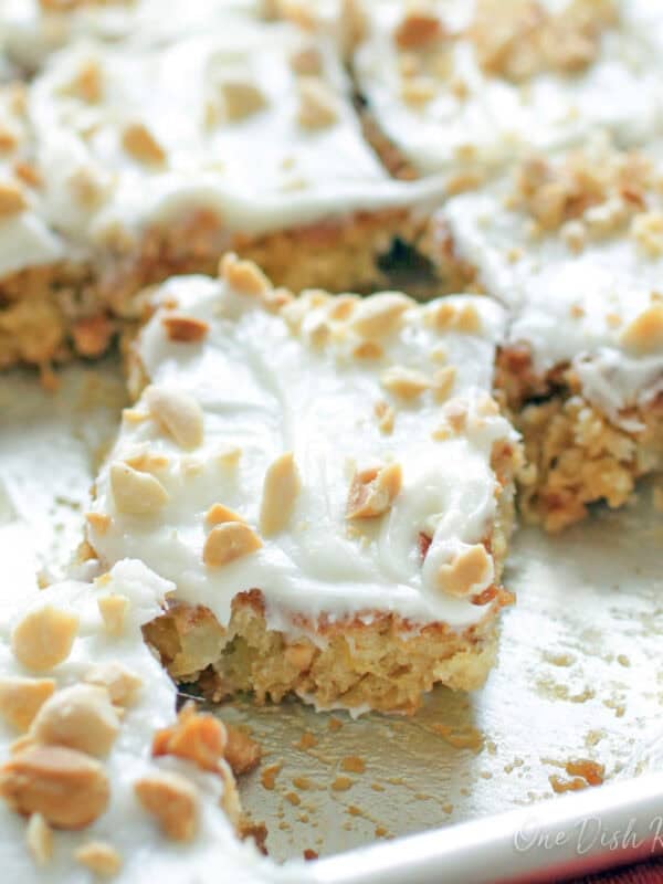a small pineapple sheet cake sliced into squares.