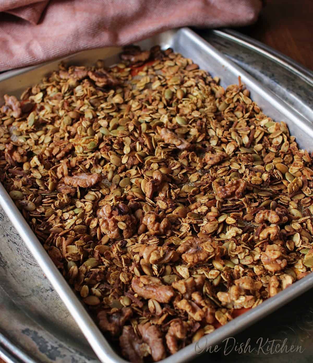 a sheet pan filled with toasted granola and nuts.